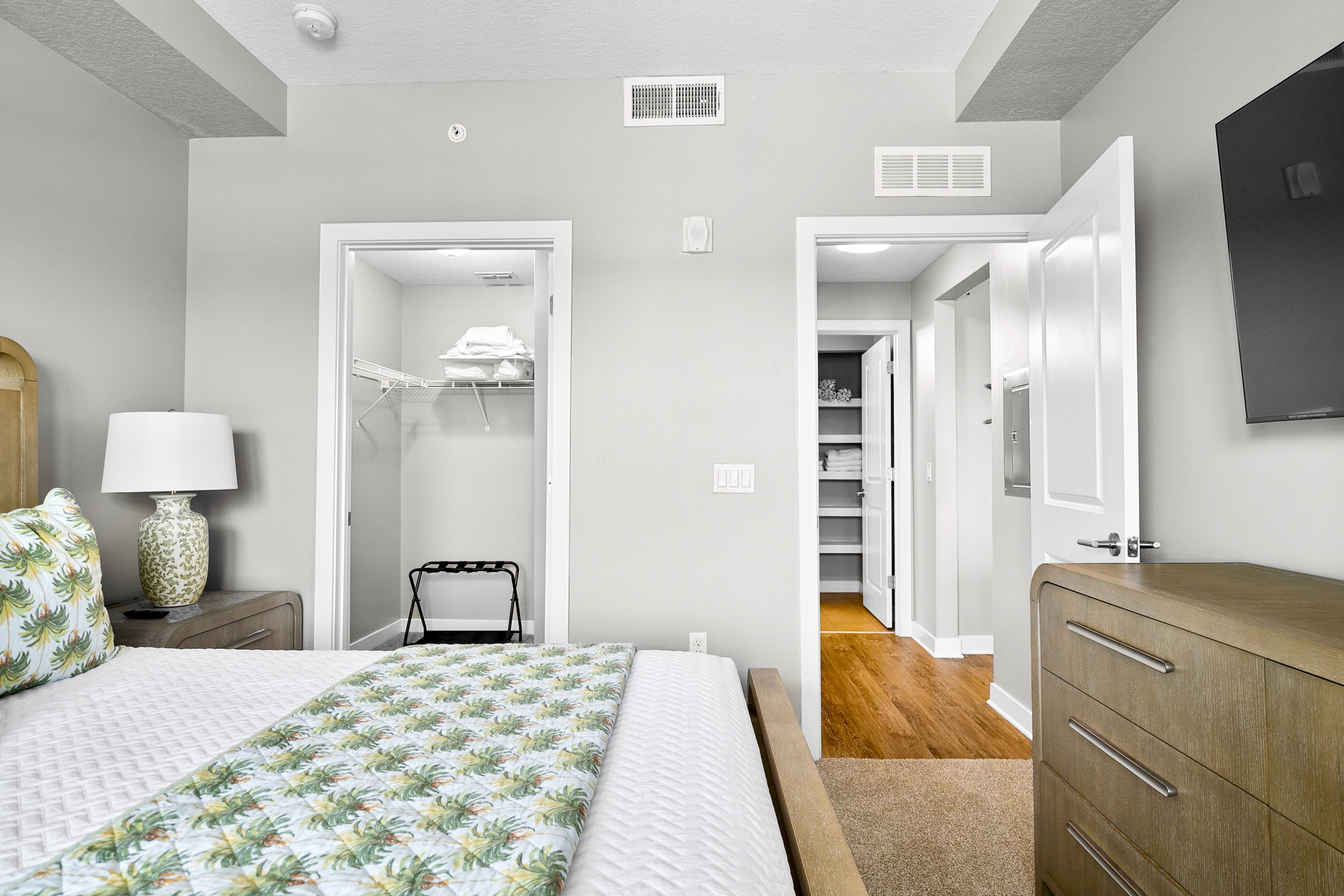 Inviting bedroom with stylish decor, spacious walk-in closet, and elegant details for a serene living experience.
