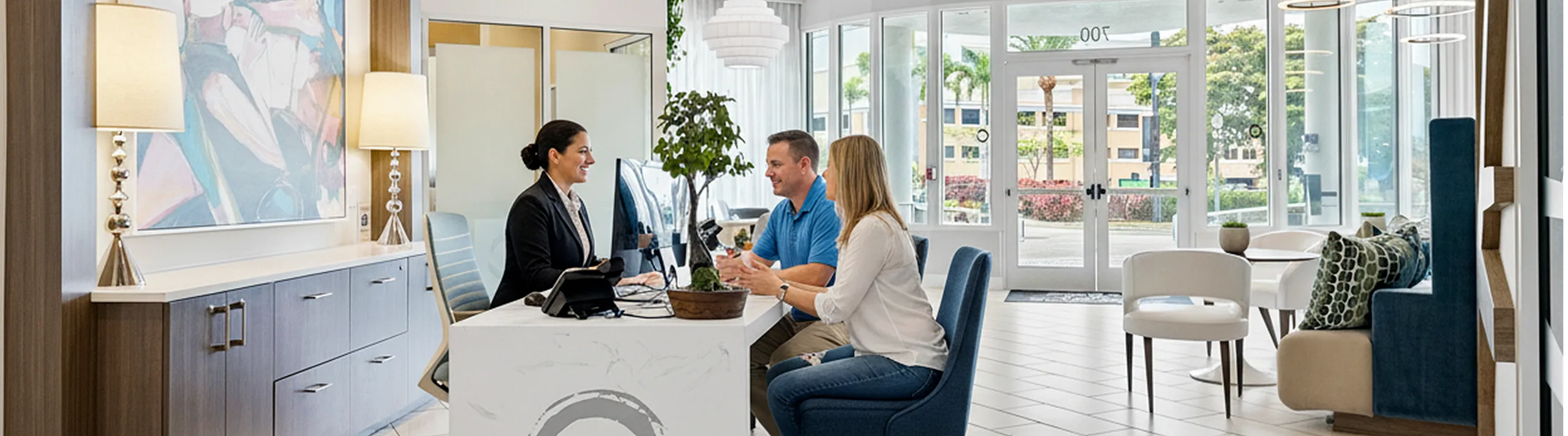 Modern apartment lobby with stylish decor, featuring a welcoming reception area and vibrant artwork, perfect for comfortable client interactions.