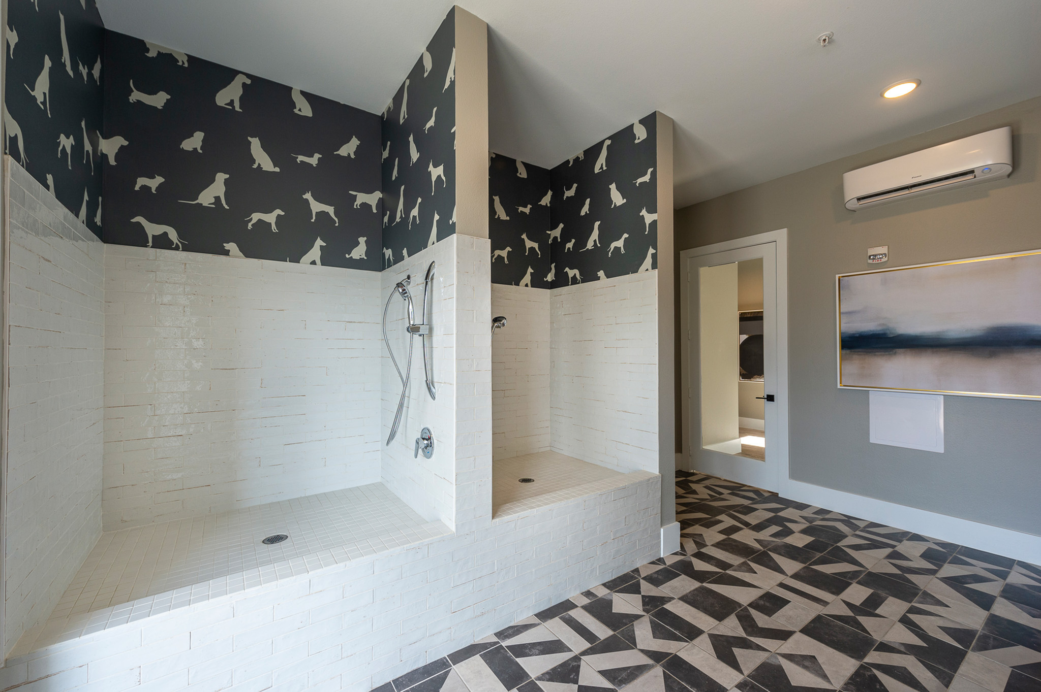 Chic, modern bathroom with playful dog wallpaper and dual showers, featuring sleek white tiling and geometric flooring.