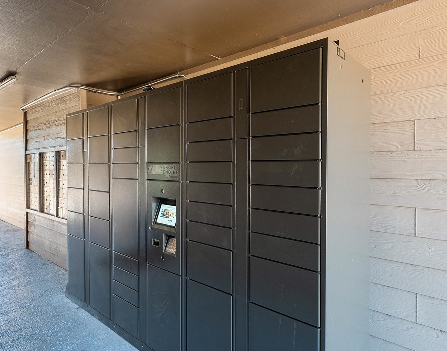 Sleek, modern parcel locker area with convenient electronic package access, enhancing security and ease for residents.