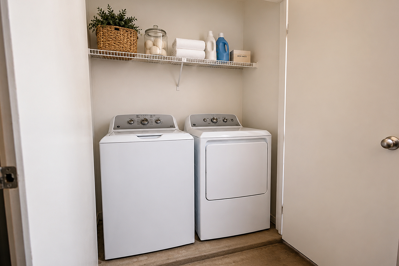 In-home laundry area with full-size washer and dryer at Brookmore Hollow Apartments in Rosenberg, TX.
