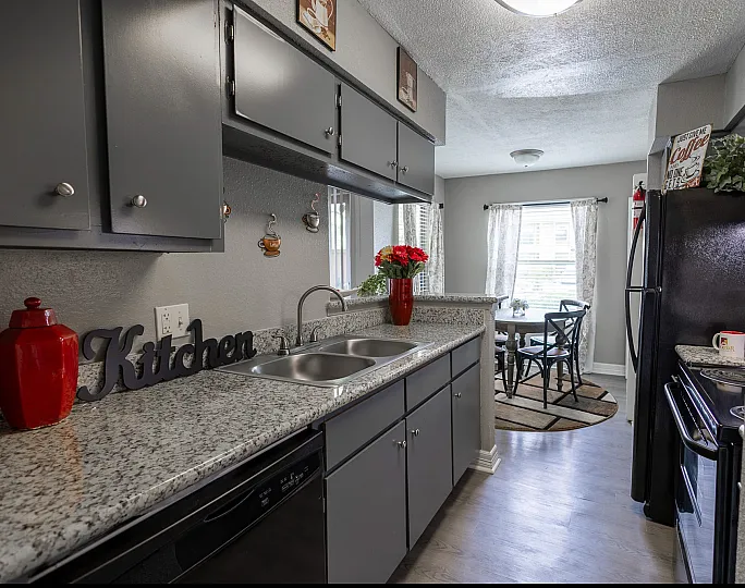 Charming kitchen with sleek gray cabinets, granite countertops, and cozy breakfast nook filled with natural light.