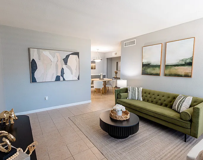 Open-concept living and dining area at Huntington Oaks Apartments in Alvin, TX.