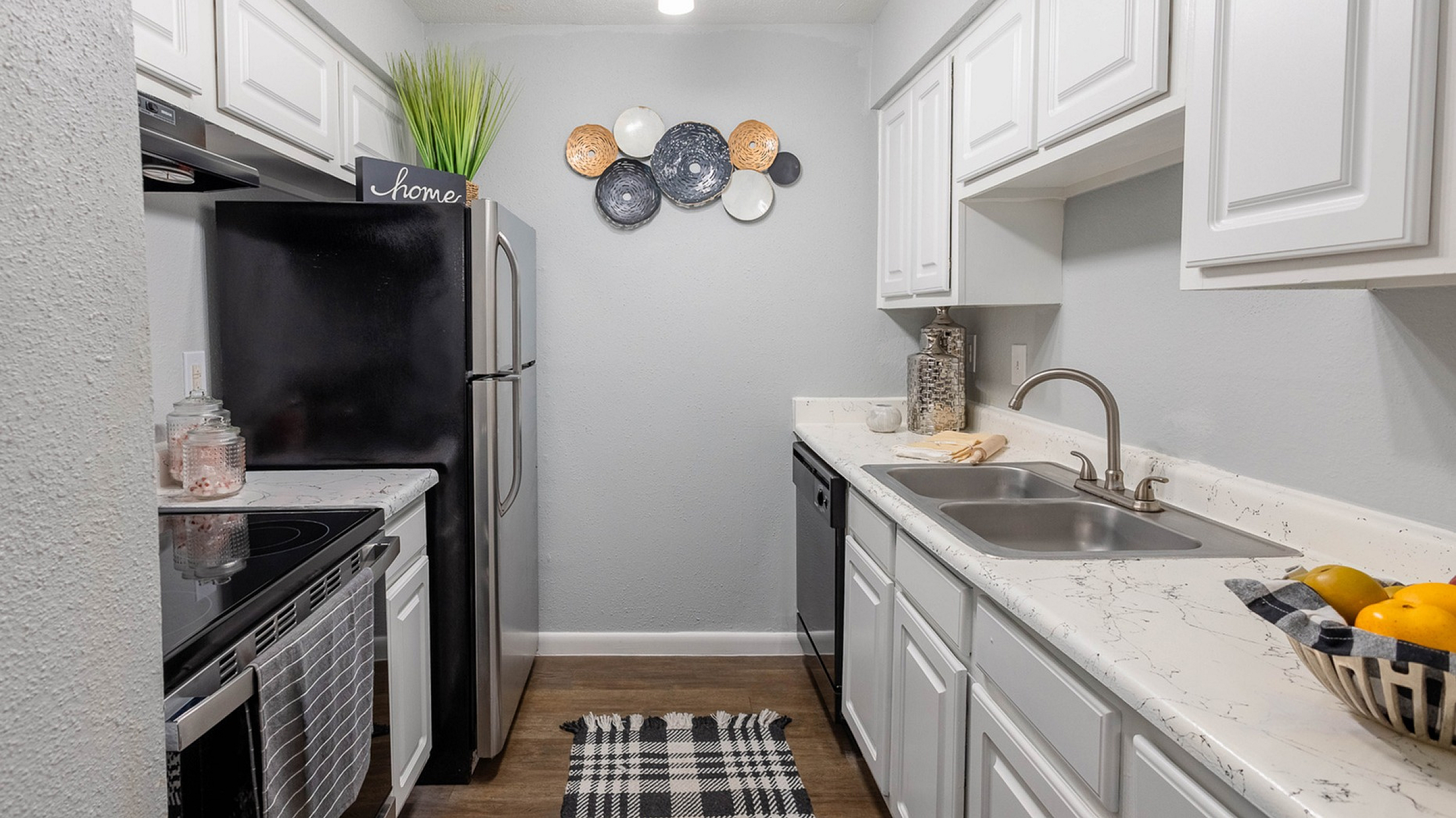 Model apartment kitchen at Steeplechase Apartments in Alvin, TX