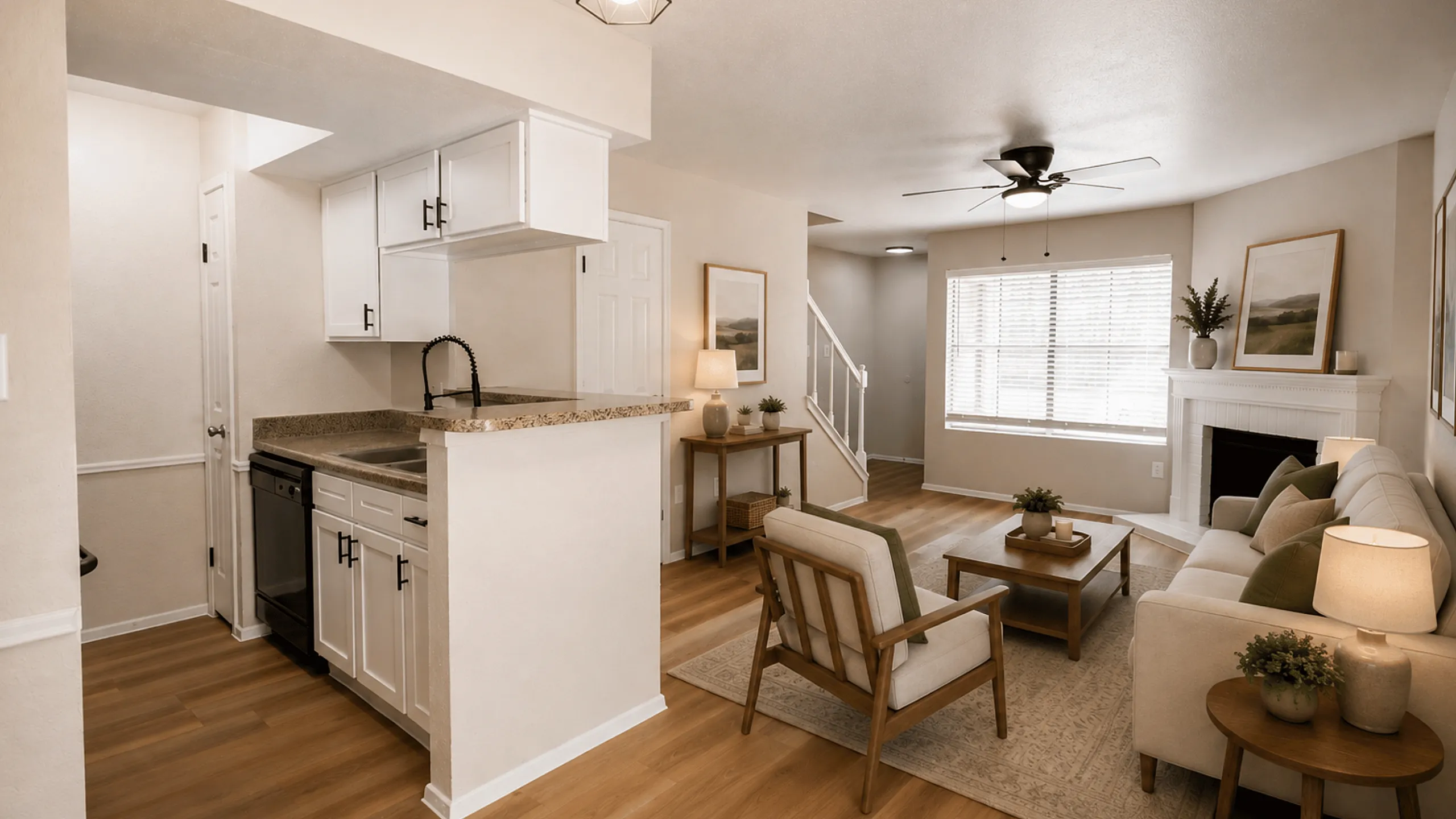 Alternate view of the Deerbrook Gardens living room in Humble, TX featuring a fireplace, comfortable seating and open-concept layout.