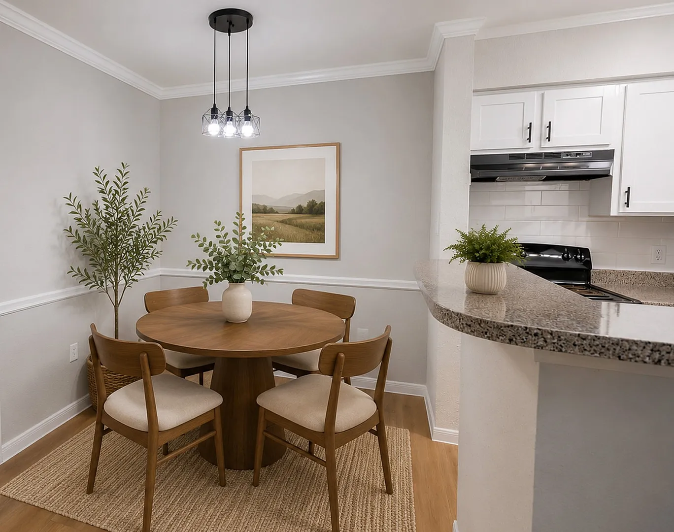 Charming dining area with a round wooden table, elegant chairs, and modern light fixture, adjacent to a sleek kitchen.