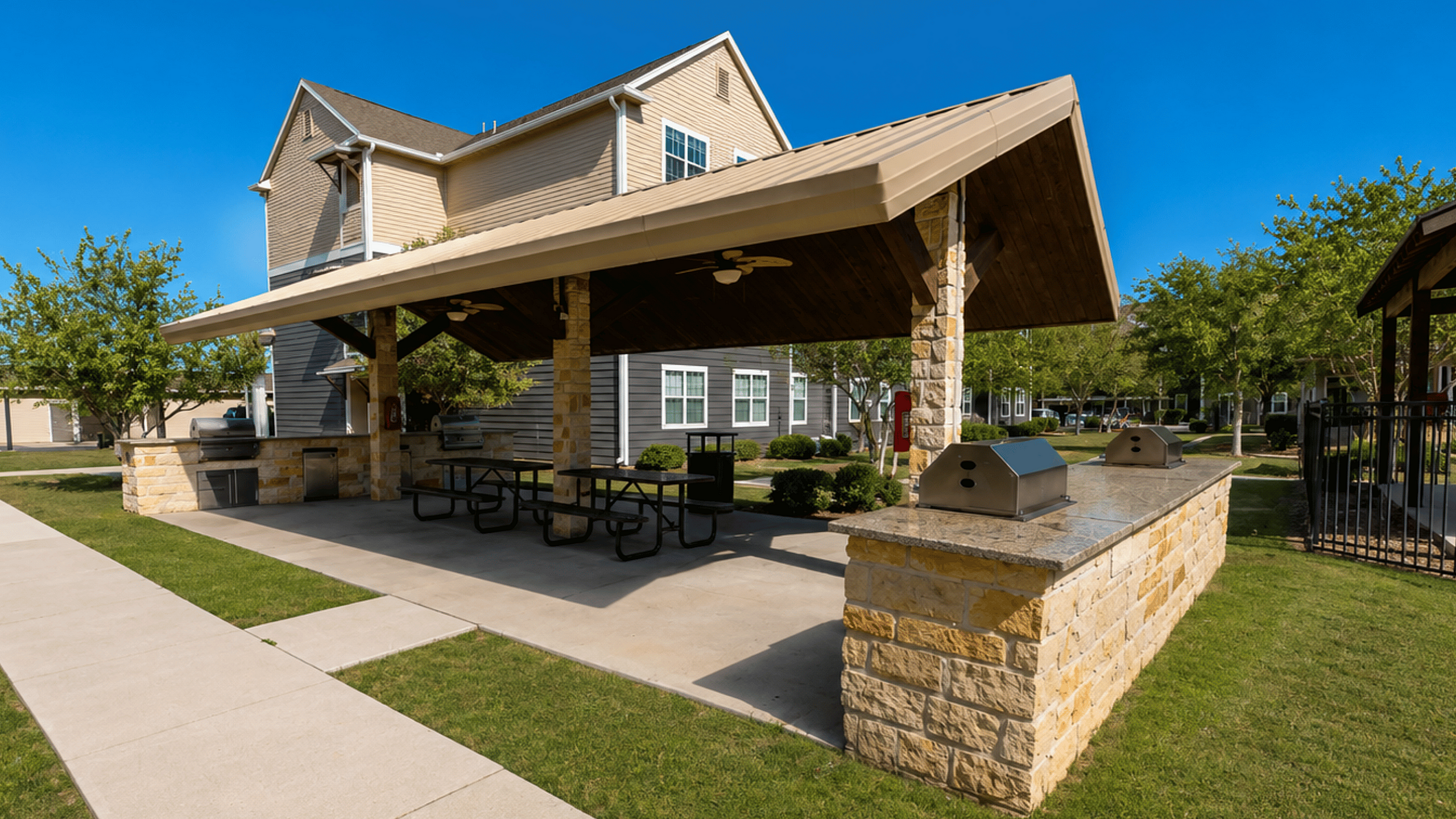 Outdoor kitchen and picnic area at Oak Tree Apartments in Kingsville, TX, designed for resident cookouts and casual gatherings.
