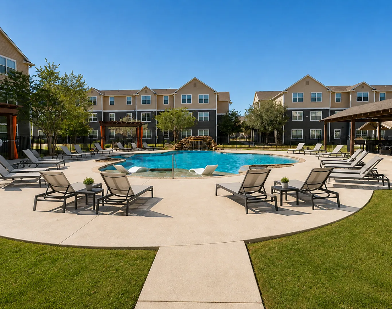 Pool and surrounding lounge area at Oak Tree Apartments in Kingsville, TX, featuring a resort-style setting for residents.