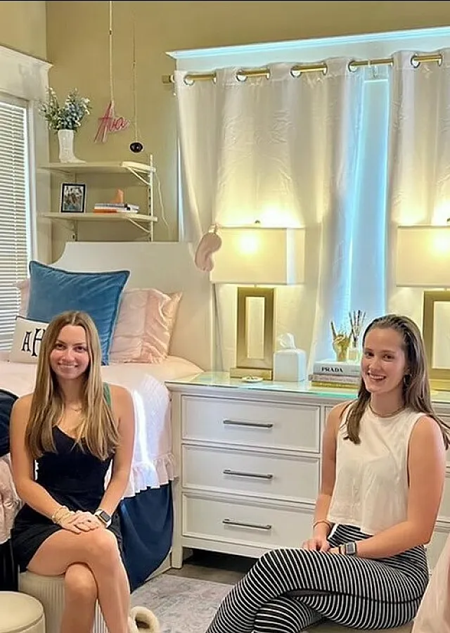 Bright and inviting shared bedroom with stylish decor, featuring two cozy beds, elegant lighting, and personalized accents.