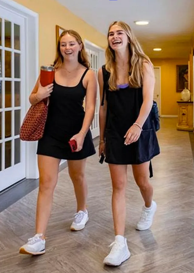 Bright hallway with stylish French doors and cheerful atmosphere, featuring two people enjoying a walk on elegant flooring.
