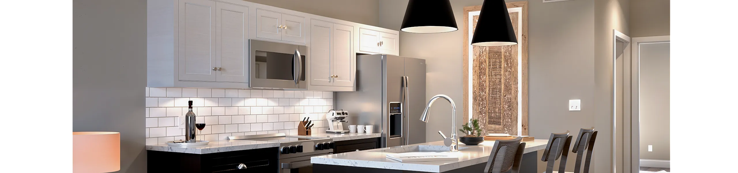 Contemporary kitchen with sleek design featuring stainless steel appliances, elegant pendant lighting, and a stylish breakfast bar with high chairs.