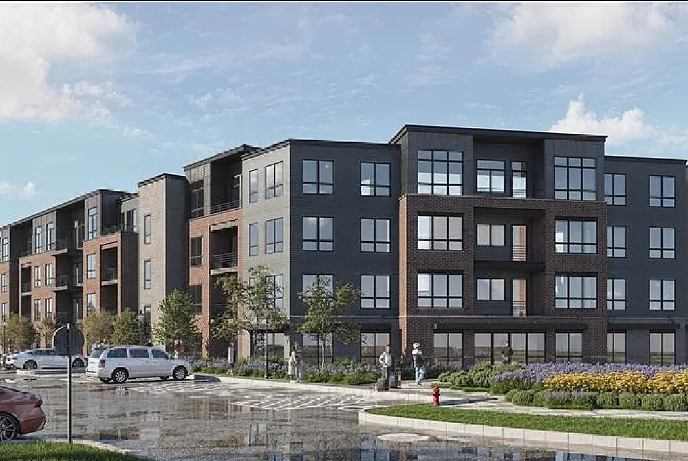 Modern apartment complex with contemporary design, featuring large windows and vibrant landscaping on a sunny day.