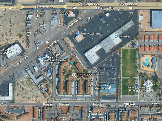 Vibrant aerial view of a well-planned neighborhood featuring diverse commercial outlets, residential spaces, and lush green areas, ideal for dynamic urban living.