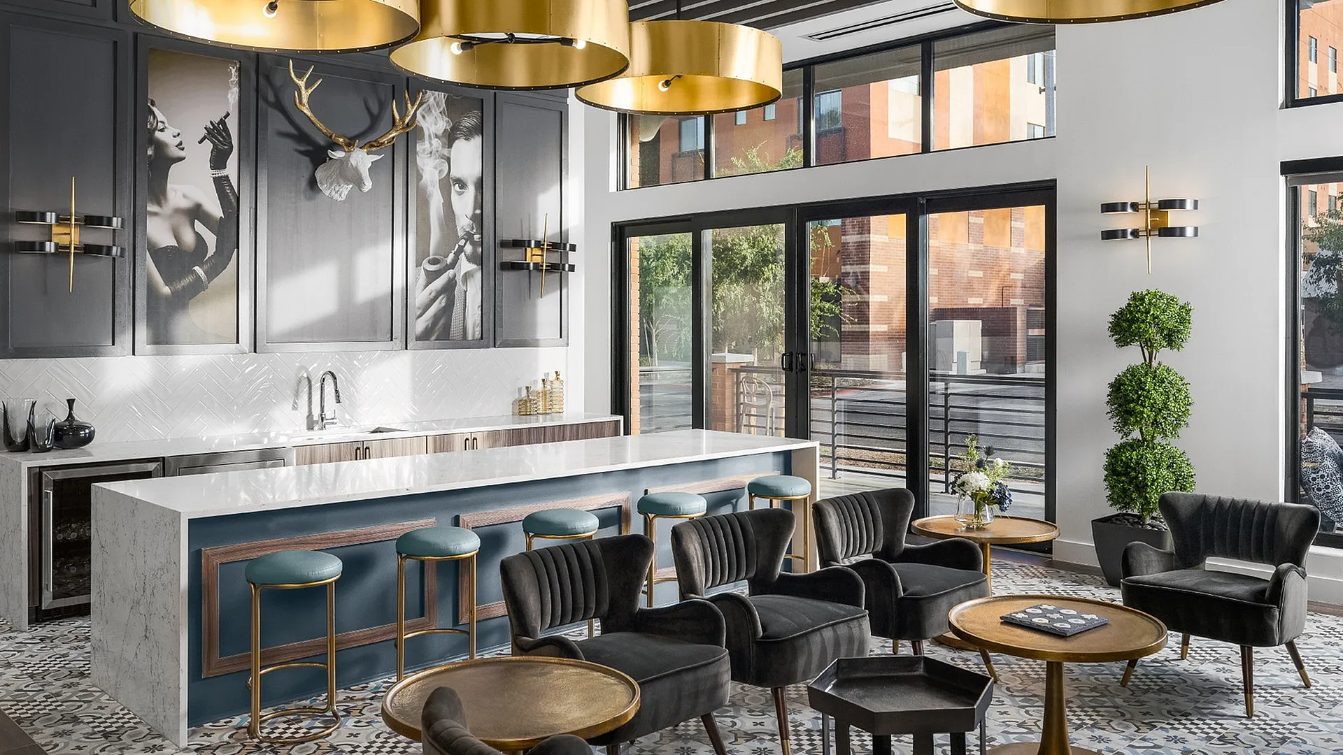 Chic apartment lounge with modern bar seating, sophisticated decor, and vibrant outdoor views through large windows.