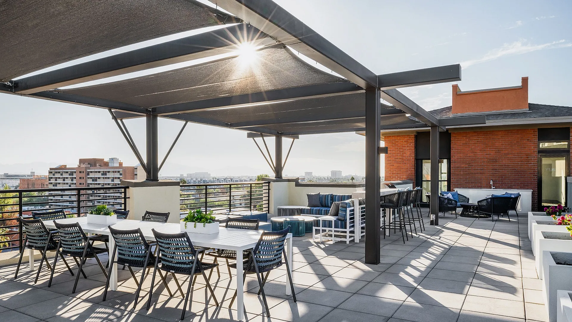 Luxurious rooftop terrace with modern pergola, stylish seating, and panoramic city views.