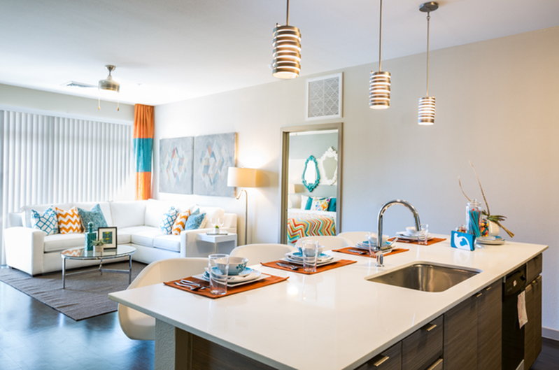 Contemporary open-concept living space with elegant white kitchen island, cozy seating area, and stylish modern decor.