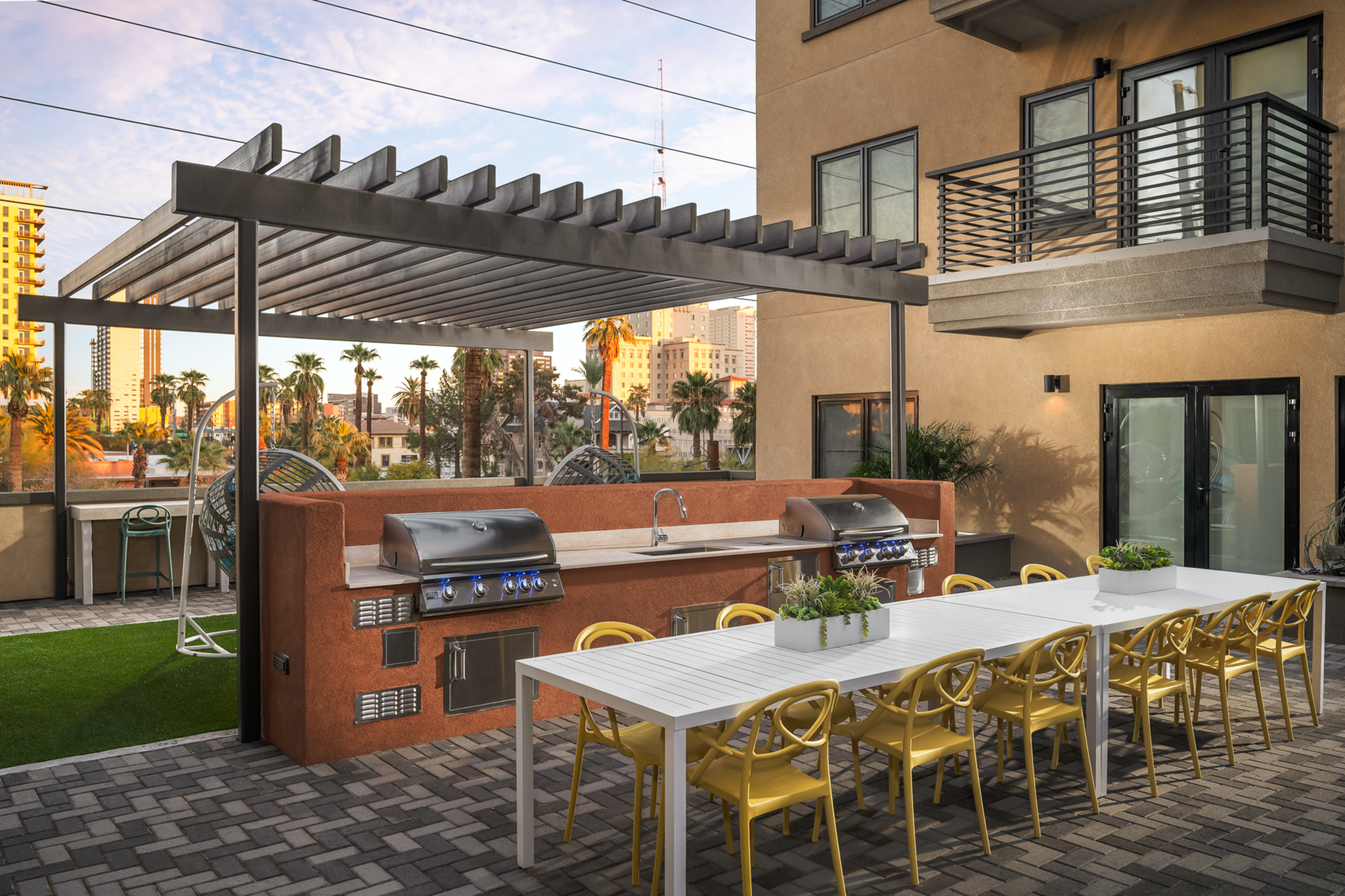 Inviting rooftop terrace with modern pergola, outdoor kitchen, and stylish dining area with city views.