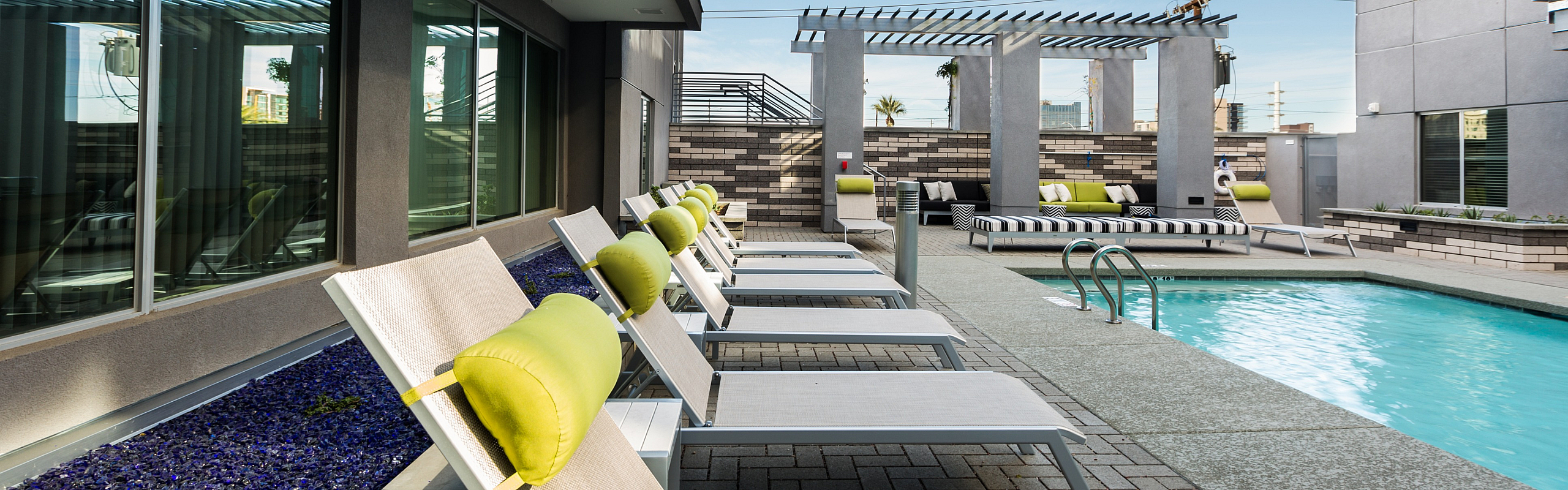 Luxurious outdoor pool area with stylish lounge chairs and contemporary design, perfect for relaxation and leisure.