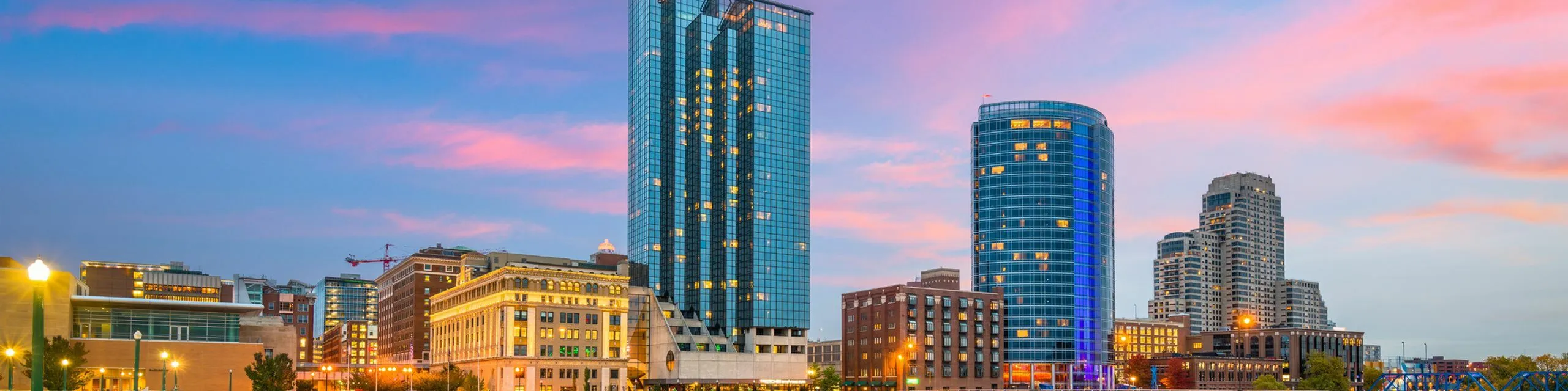 Vibrant urban skyline with modern skyscrapers against a stunning sunset backdrop, showcasing the lively cityscape.