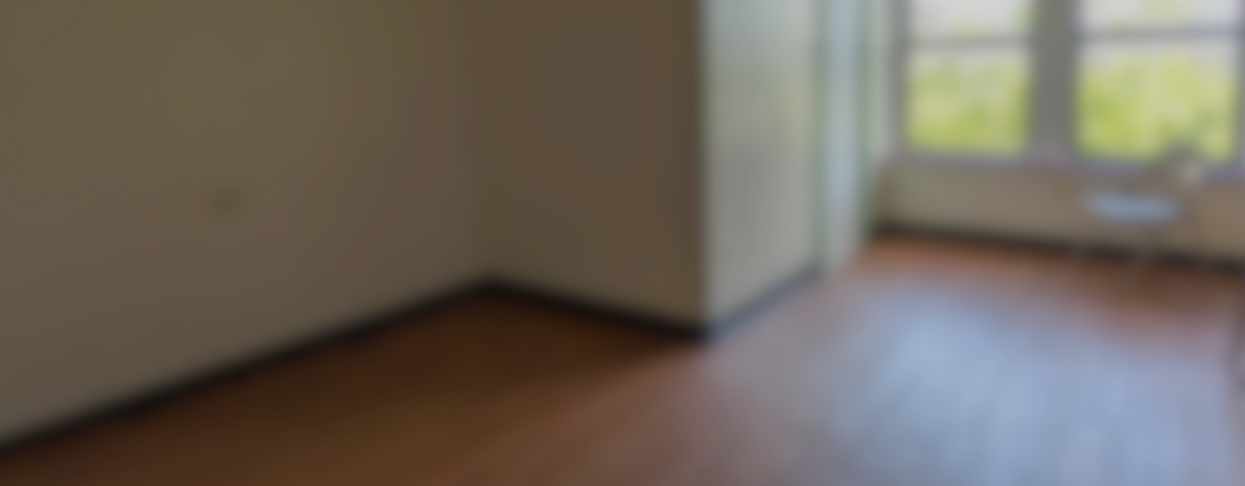 Bright and spacious empty room with large windows offering natural light and a serene view, ideal for any modern apartment.