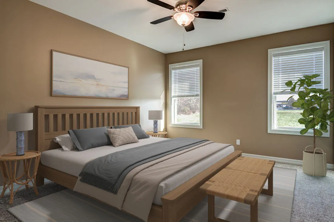 Elegant bedroom with a cozy king-size bed, modern ceiling fan, and natural light coming through large windows.