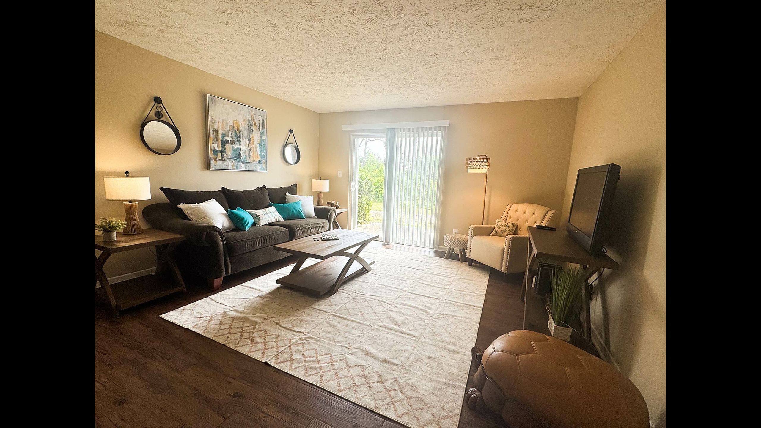 Inviting living room with cozy brown sofa, elegant decor, and large window for natural light in modern apartment.