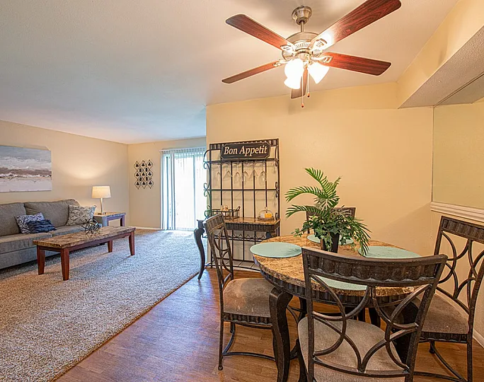 Inviting living and dining area with cozy seating, elegant table setting, and modern decor, perfect for relaxation and entertaining.