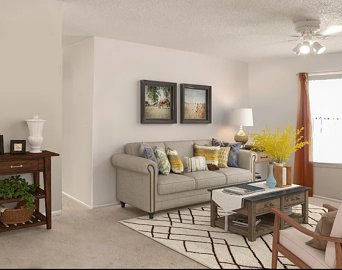 Inviting living room with a cozy beige sofa, vibrant pillows, elegant wooden furniture, and bright natural light flowing through a window.