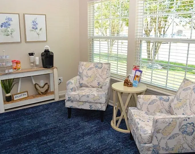 Inviting apartment interior with cozy dining area, stylish decor, and glimpses of warmly lit bedrooms.