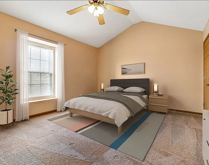 Inviting bedroom with soft lighting, elegant decor, spacious feel, and a ceiling fan for comfort.