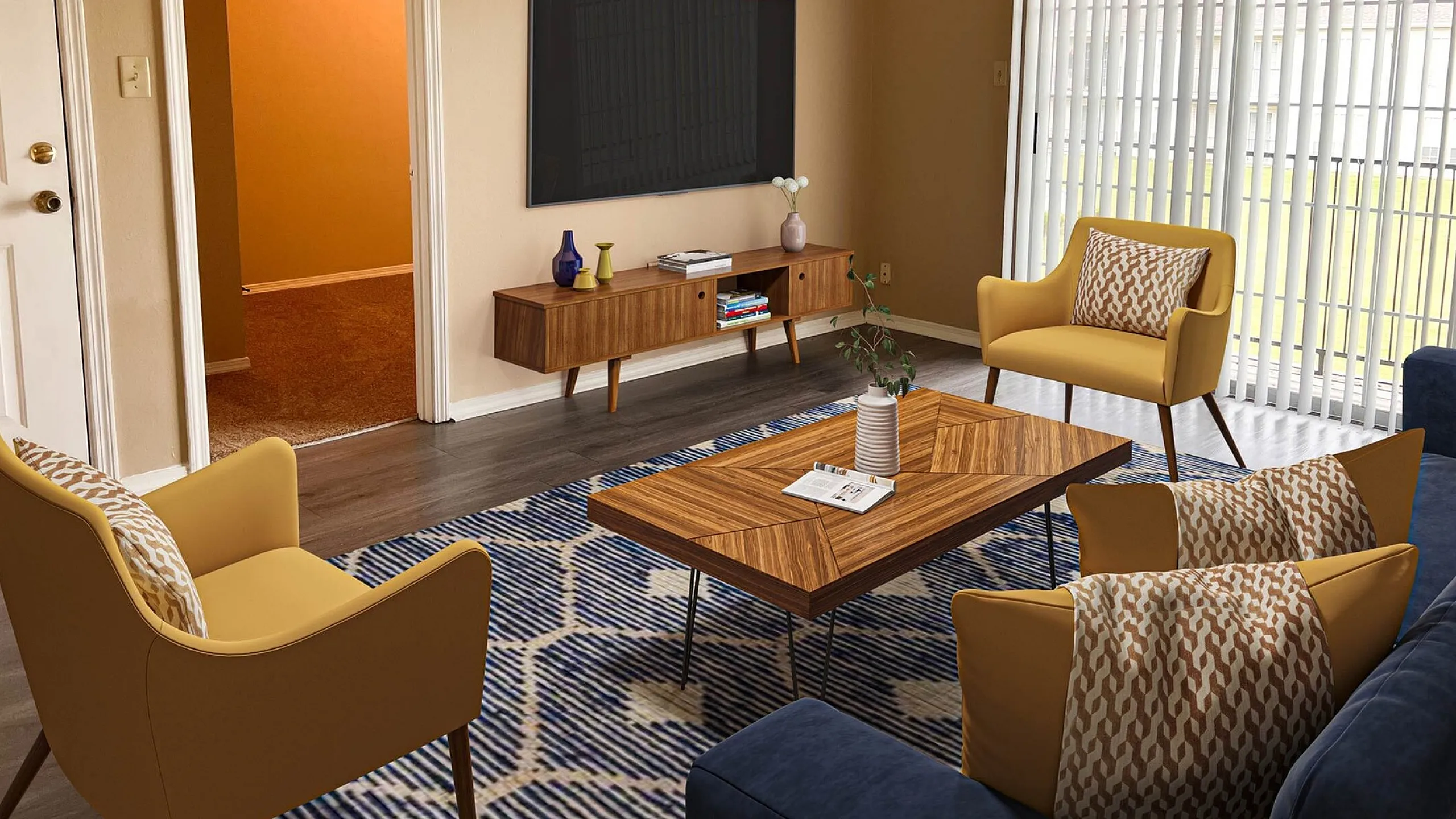 Welcoming living room with contemporary furnishings, featuring mustard armchairs, a sleek wooden coffee table, and a wall-mounted TV, framed by large windows with vertical blinds.