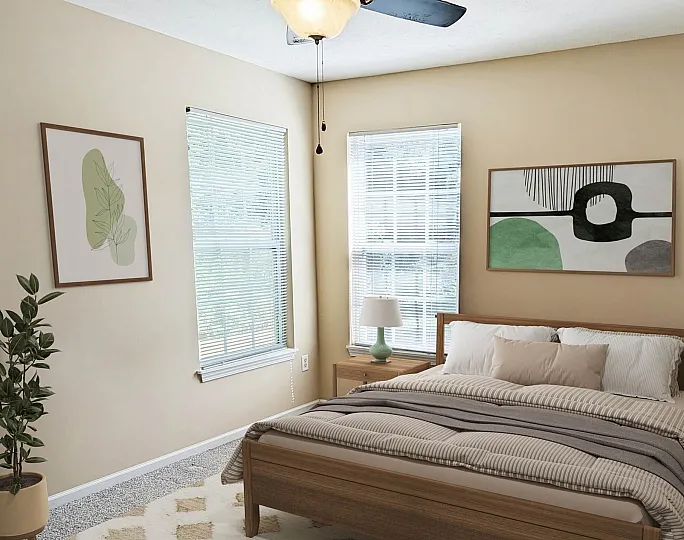 Cozy bedroom with modern decor, featuring a comfortable bed, stylish artwork, and ample natural light from large windows.