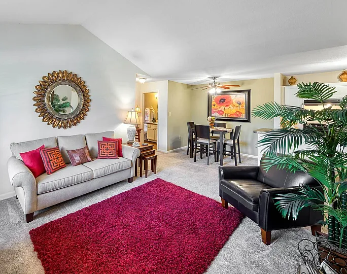 Inviting living room with plush seating, vibrant decor, and open dining area in modern apartment.