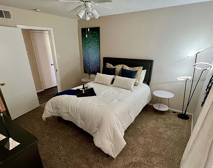 Cozy and elegant bedroom with modern decor, featuring a plush bed, sleek lighting, and stylish artwork for a relaxing retreat.