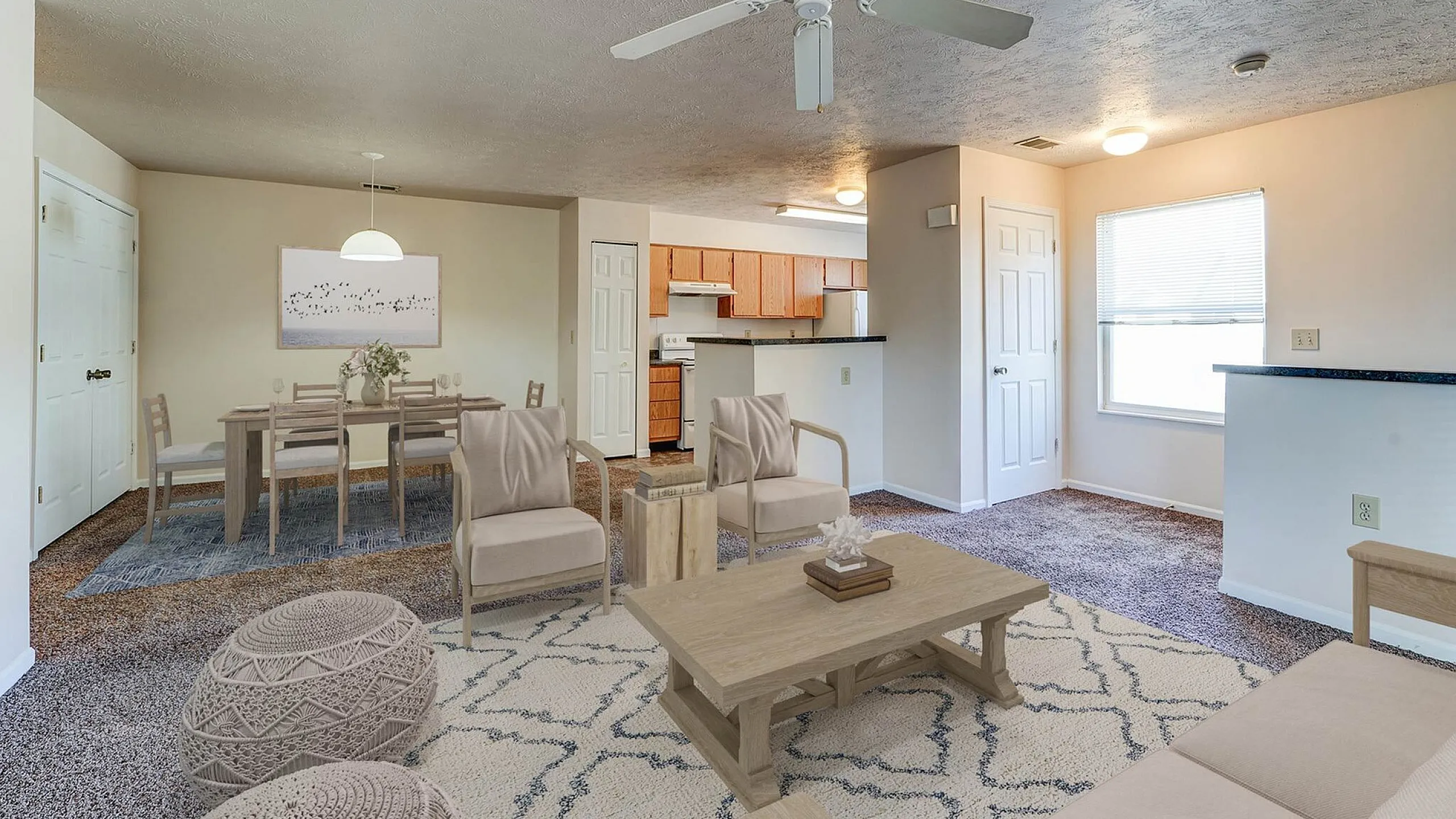 Bright open-concept living room with modern decor, cozy carpeting, and adjacent dining area; features an inviting kitchen with wooden cabinetry.