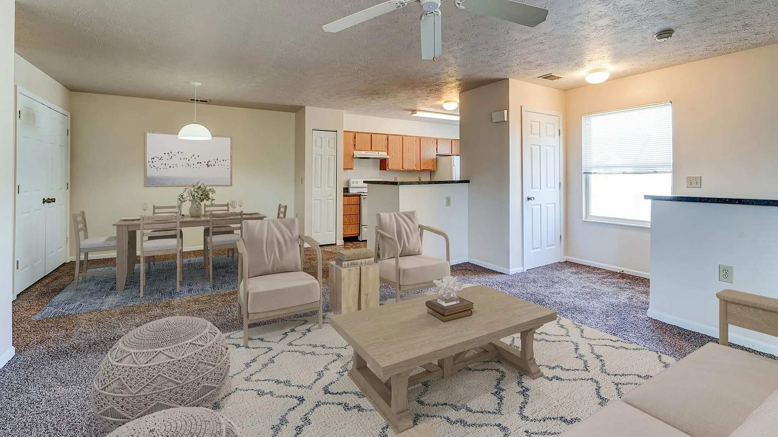Inviting open-concept living space showcasing a chic dining area, cozy seating with modern accents, and a warm kitchen, perfect for entertaining.