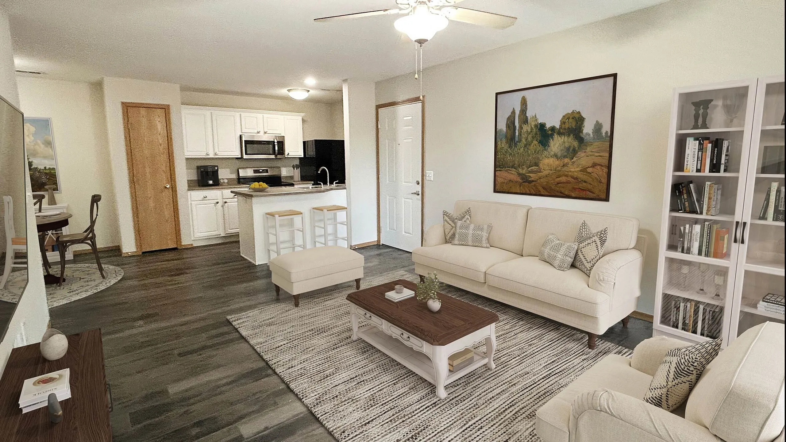 Bright and inviting open-concept living space featuring a modern kitchen with white cabinets, comfortable seating area, and tasteful d&eacute;cor, ideal for relaxation and gatherings.