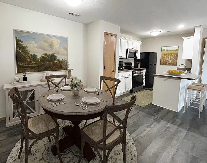 Charming apartment interior showcasing an elegant dining area with rustic chairs, modern kitchen with sleek appliances, and inviting decor.