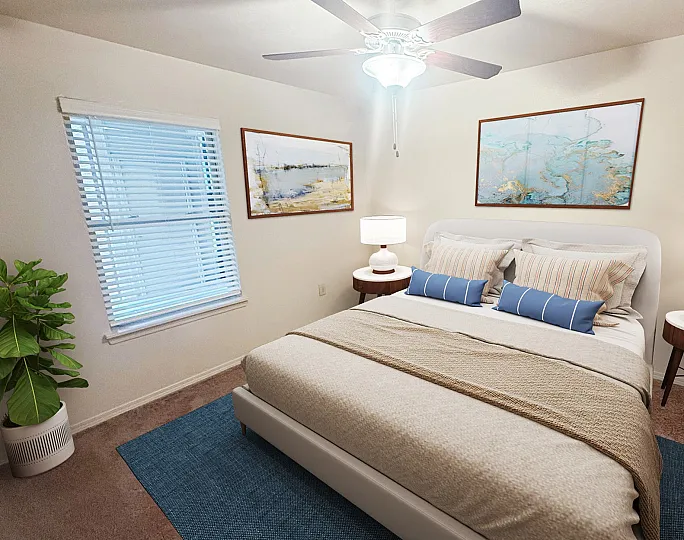 Cozy and elegant bedroom with stylish decor, featuring a comfortable bed, modern ceiling fan, vibrant artwork, and inviting natural light.