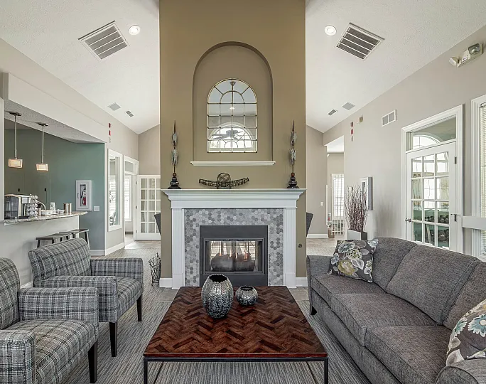 Inviting living room with vaulted ceilings, elegant fireplace, and cozy seating, perfect for relaxation and gatherings.