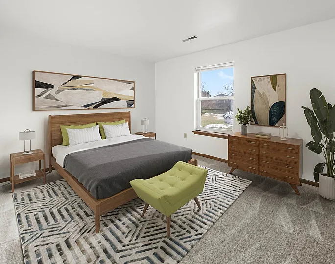 Bright and elegant bedroom with modern decor, featuring a wooden bed frame, geometric patterned rug, and a cozy green ottoman. Large window for natural light and stylish artwork on the walls.