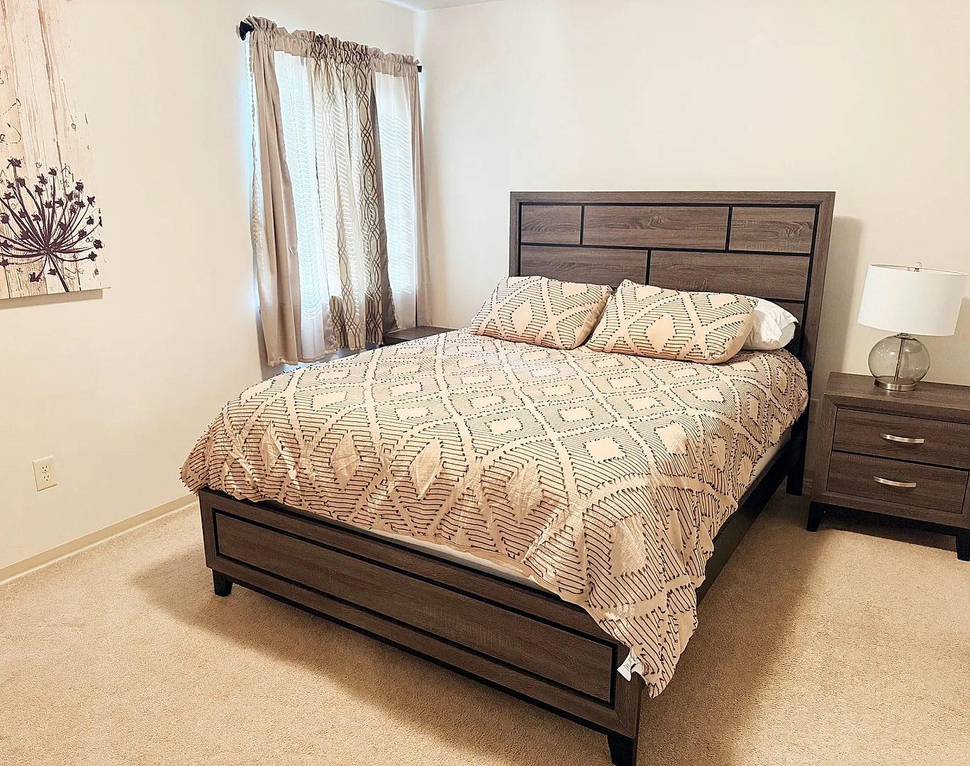Inviting bedroom with elegant wood furniture, contemporary lamp, and chic patterned bedding, creating a cozy and modern ambiance.