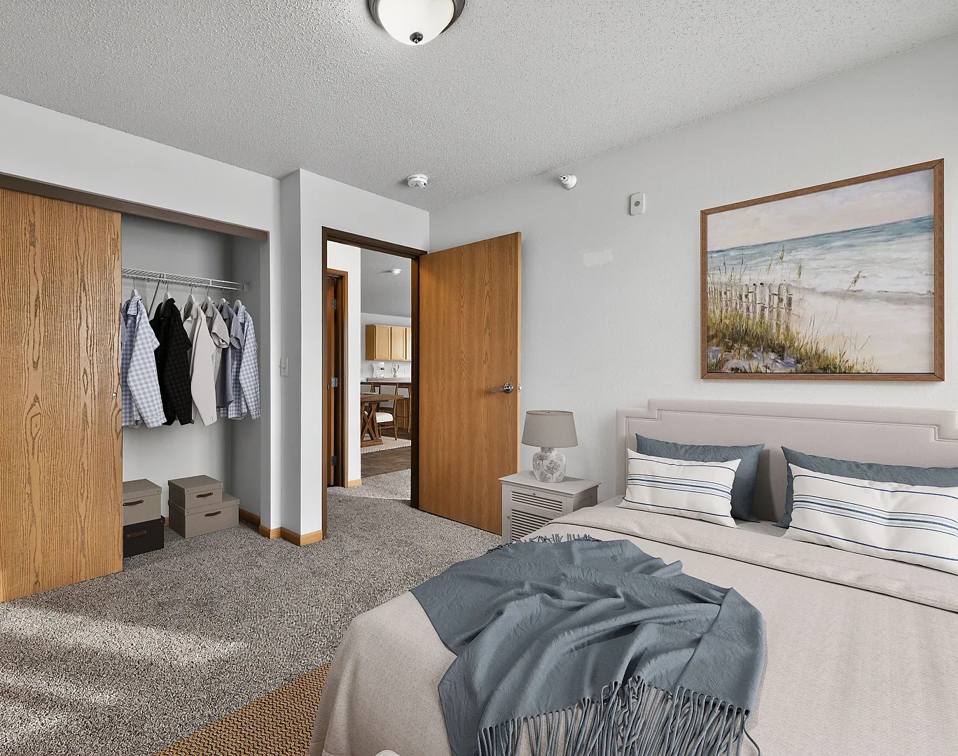 Inviting bedroom with cozy carpet, stylish closet space, and serene beach artwork.