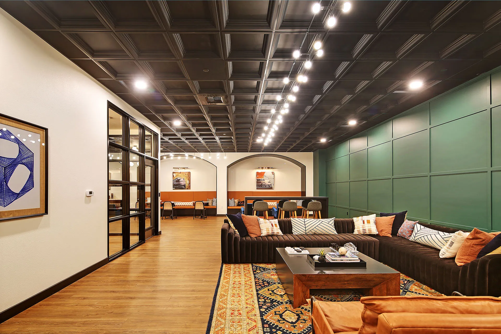 Elegant lounge area with stylish seating, modern lighting, and a chic accent wall, perfect for relaxation and social gatherings.