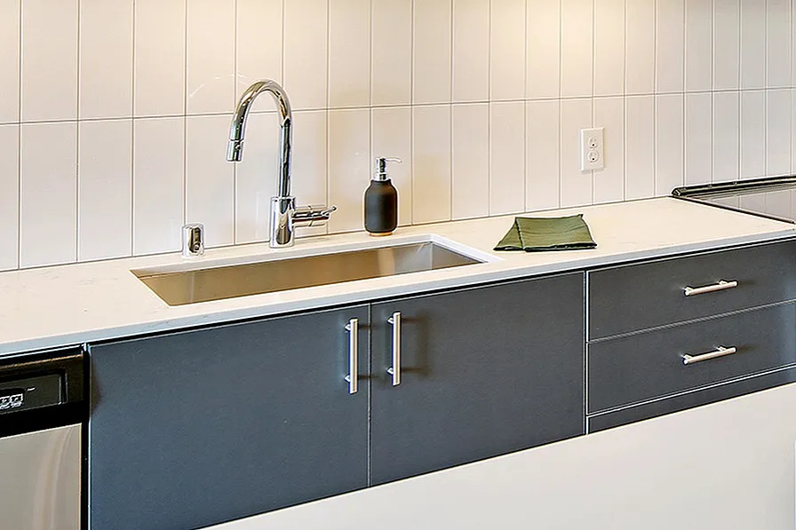 Modern kitchen with sleek cabinetry, stainless steel appliances, and a chic dining area, exuding contemporary elegance.