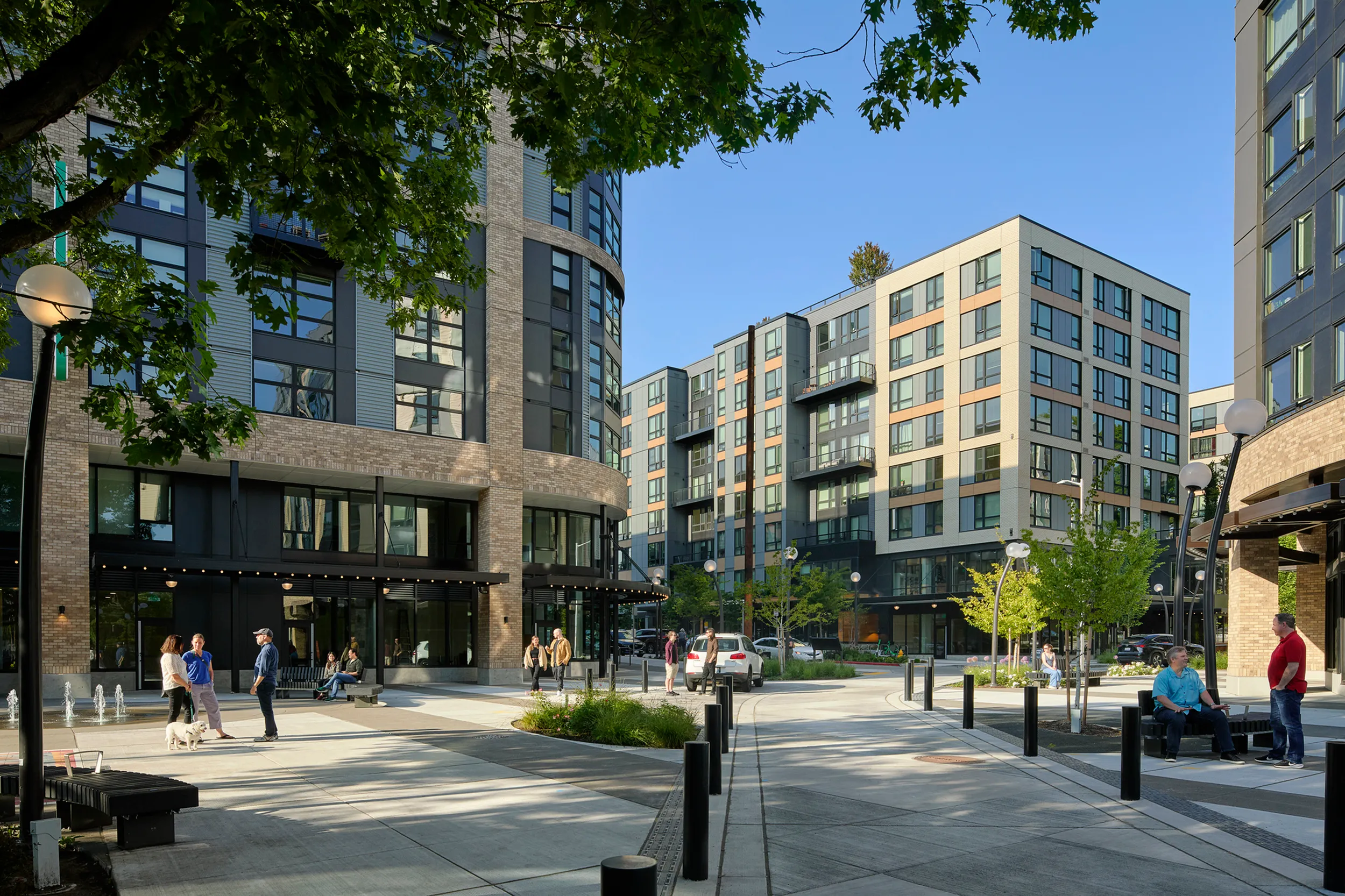Modern urban apartment complex with contemporary architecture, vibrant community space, and lush greenery.
