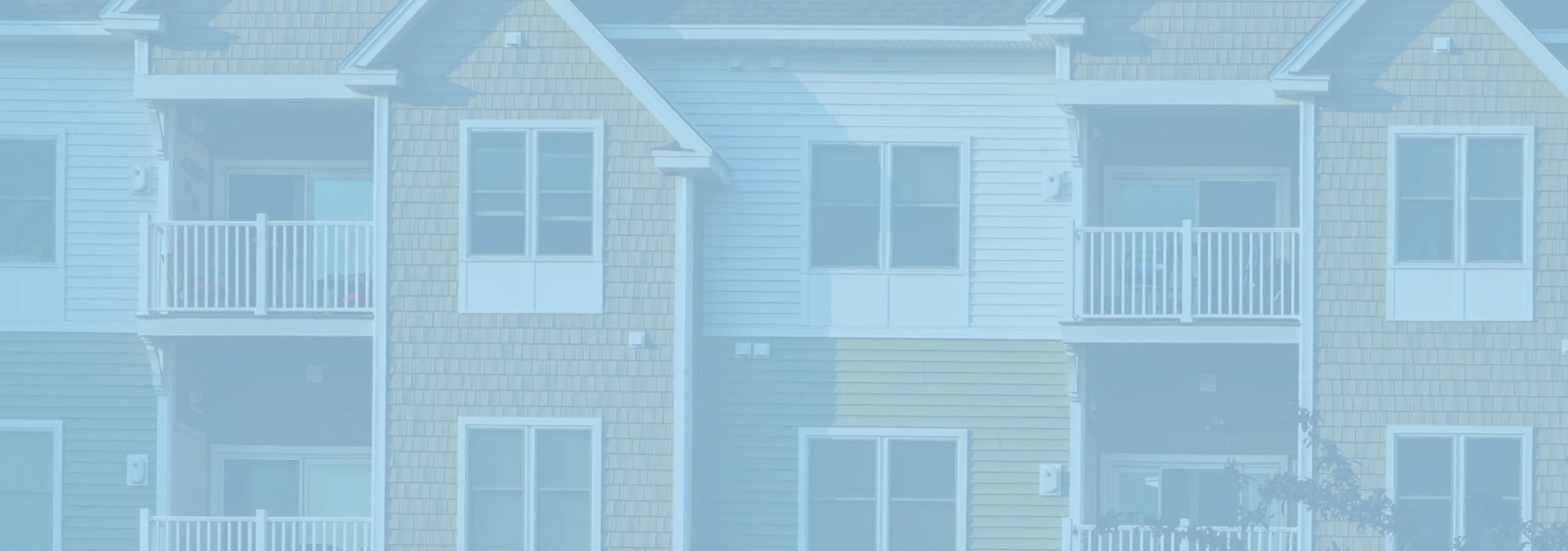 Charming apartment exterior with inviting balconies and modern architectural design.