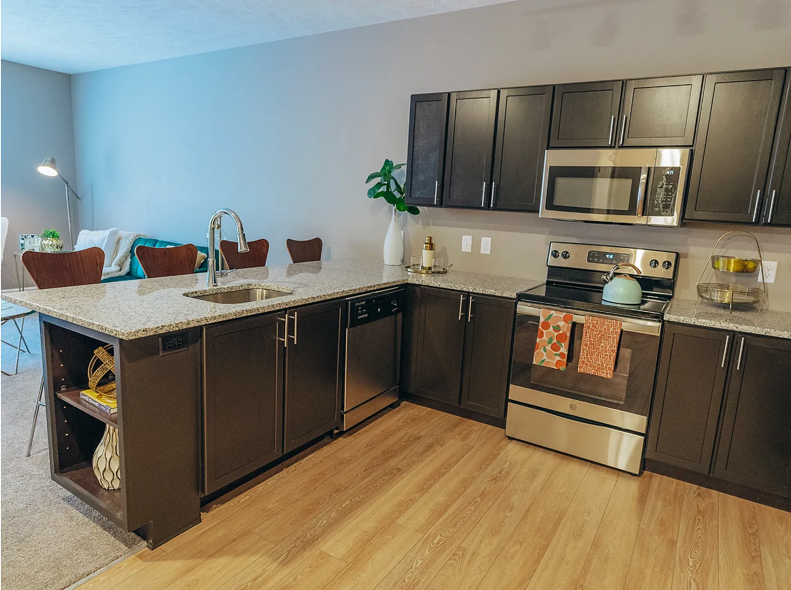 Chic kitchen with modern appliances, sleek cabinetry, and a cozy dining area in an inviting open-plan living space.