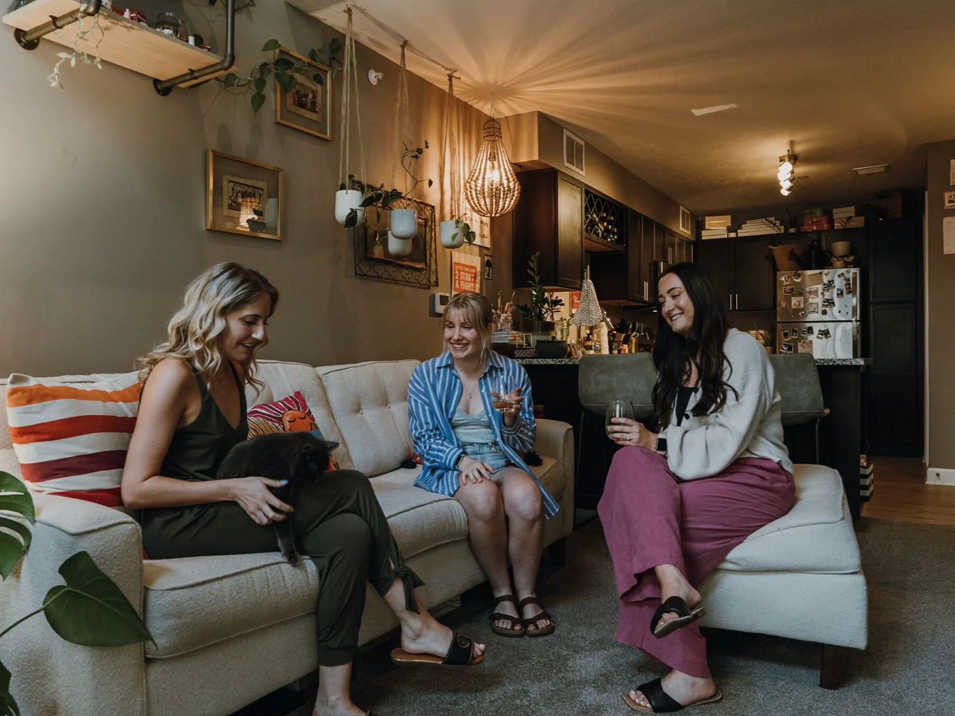 Charming living room setup with friends enjoying a cozy evening, modern decor, and warm lighting.