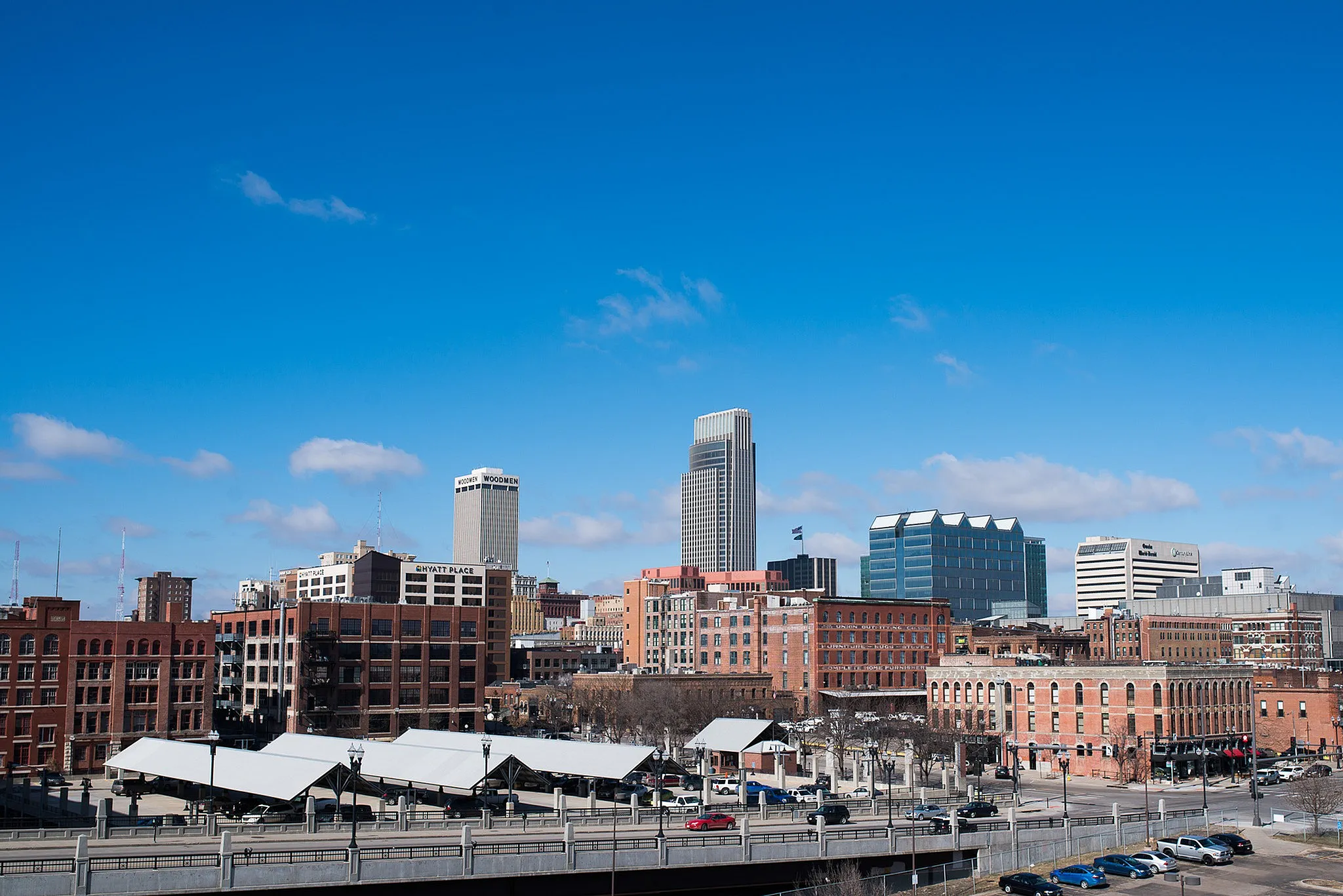 Vibrant urban skyline showcasing modern architecture and bustling streets under a clear blue sky.